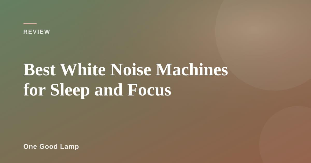 Compact white noise machine on a nightstand next to a lamp